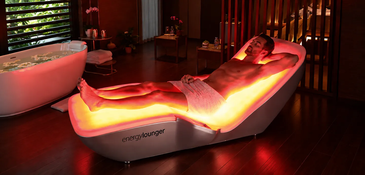 EnergyLounger full-body red light therapy lounger in a spa setting